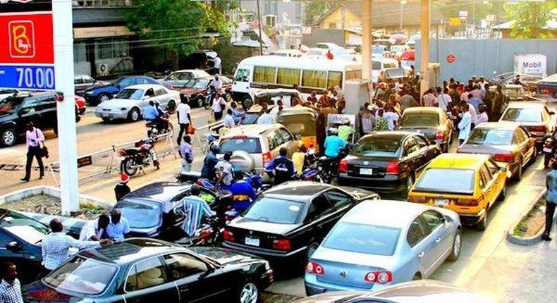 An illustrative photo of Nigerians queueing to buy petrol. 