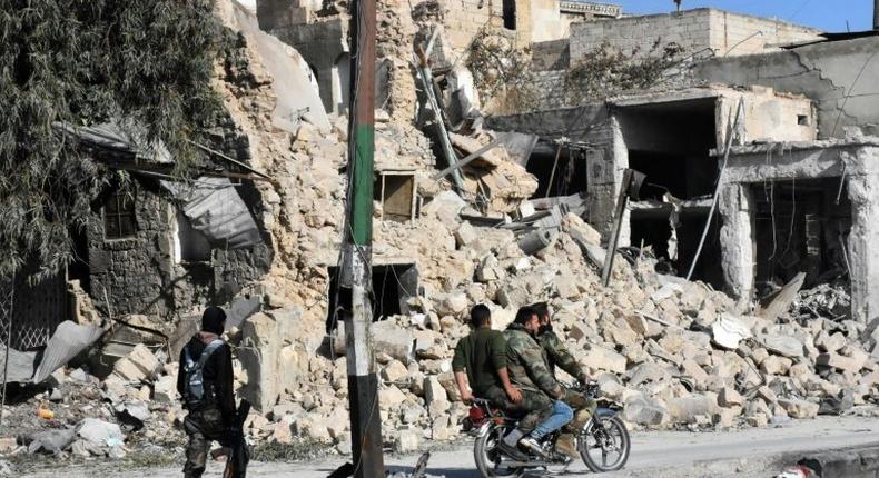 Syrian pro-government forces patrol the Bab al-Hadid neighbourhood in Aleppo's Old City, after taking control of the area from rebels