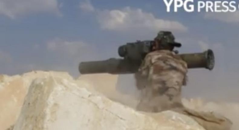 A YPG fires an anti-tank guided missile at a Turkish military vehicle.