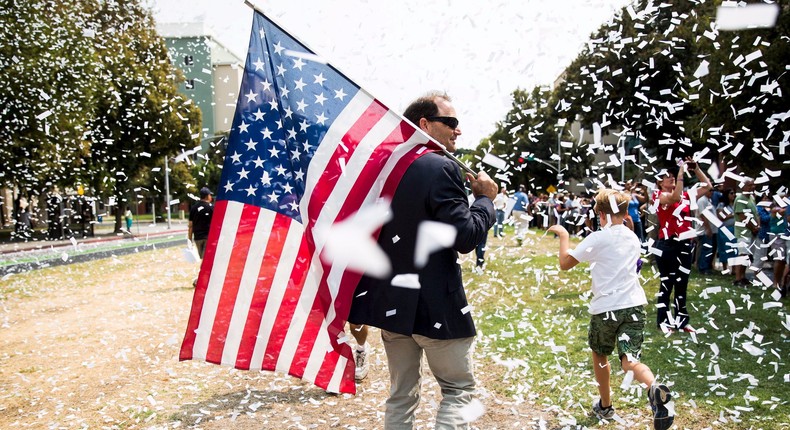 Tim DeWitt carries a U.S. flag during a parade honoring Alek Skarlatos, Spencer Stone and Anthony Sadler (not pictured), who helped thwart an attack on a French train last August, during a parade honoring them in Sacramento, California September 11, 2015.