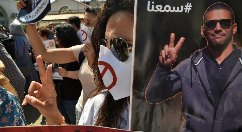 Algerians carry portraits of journalist Khaled Drareni during a rally to protest against his imprisonment in the capital Algiers on September 7