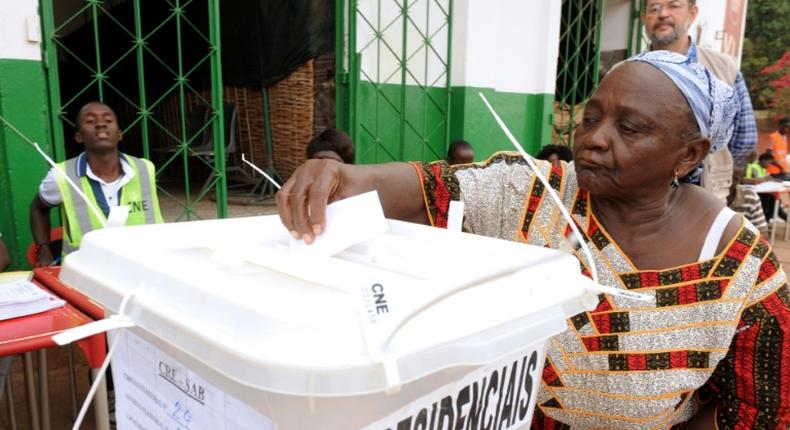 A woman casts her ballot to vote in the second round of the presidential election on May 18, 2014 in Guinea-Bissau; the country will hold a legislative election March 10, 2019