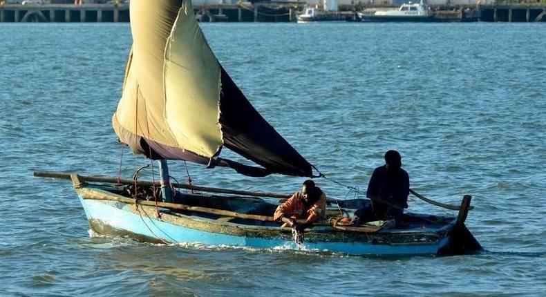 A fisherman bails out his boat in Maputo, Mozambique, May 18, 2016. 