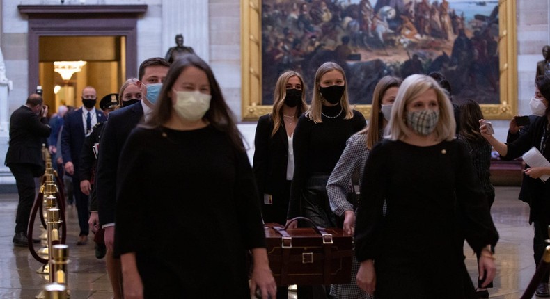 Senate staff carry a box containing the Electoral College votes for certification on January 6, 2021.