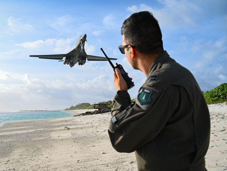 A US Air Force officer uses a land mobile radio as a B-1B bomber lands at in Diego Garcia in October 2021.US Air Force/Staff Sgt. Hannah Malone