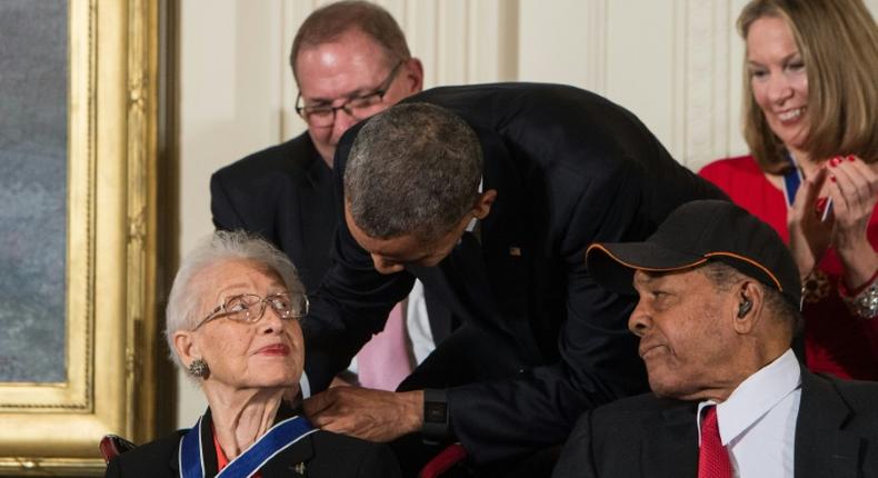 Katherine Johnson, seen here receiving the Presidential Medal of Freedom from Barack Obama, provided pivotal contributions to American space flight research alongside Dorothy Vaughan and Mary Jackson