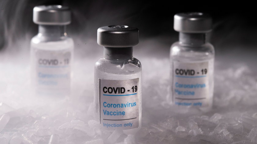 Vials labelled "COVID-19 Coronavirus Vaccine" are placed on dry ice in this illustration