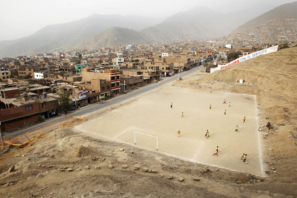 Children play soccer in Huaycan shanty town in Lima
