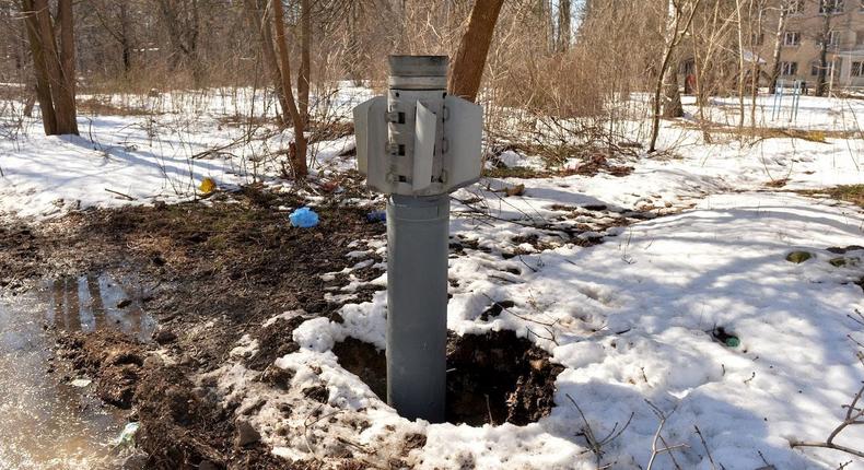 An unexploded tail section of a 300mm missile which appear to contain cluster bombs is embedded in the ground after shelling on the northern outskirts of Kharkiv, on March 21, 2022.