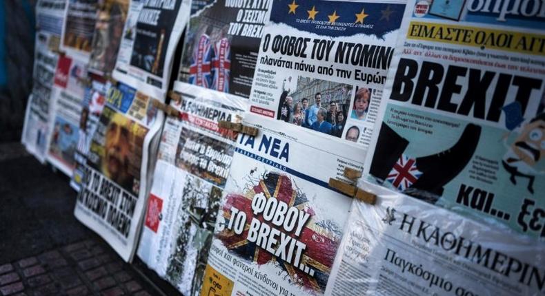 A picture taken on June 25, 2016 in Athens shows the front page of the Greek newspaper Ta Nea (C) reading be afraid of Brexit