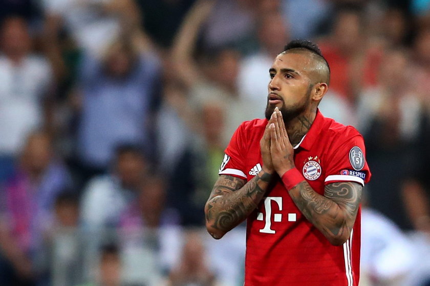 Bayern Munich's Arturo Vidal looks dejected after being sent off as Real Madrid's Sergio Ramos looks