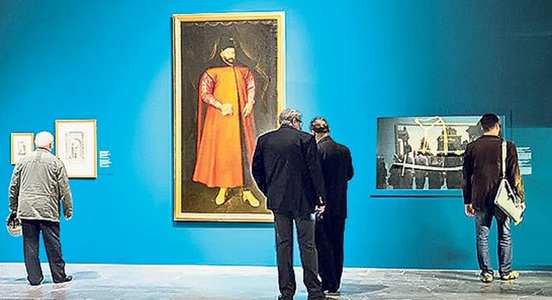 Visitors view paintings and other items on display at the exhibition “Ottomania: The Ottoman Orient in Renaissance Art on its opening day at the National Museum in Krakow.