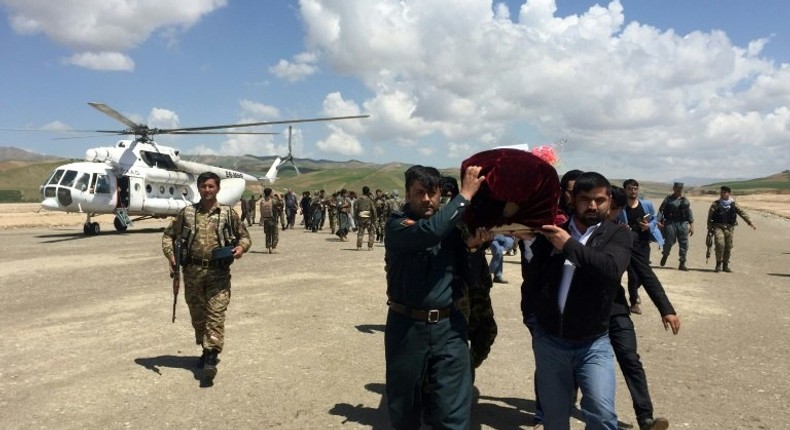 Relatives carry the coffin of a Afghan National Army soldier killed during a Taliban attack in Takhar Province. NATO will supply more troops following recent Taliban gains