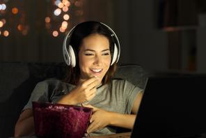 Woman watching online tv in the night