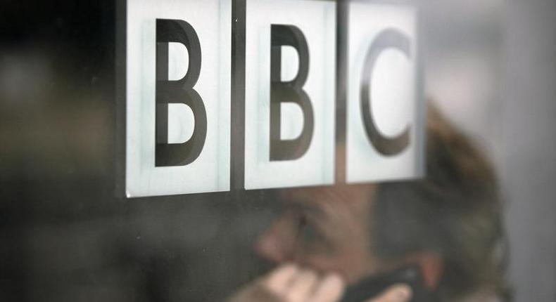 A man talks on a mobile phone inside the BBC headquarters in London November 21, 2008. REUTERS/Andrew Winning