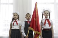 Children attend a ceremony for the inauguration of new members of the Pioneer Organization in Stavro