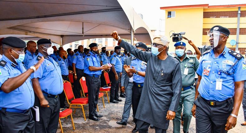 R-L: Lagos State Commissioner of Police, Mr Hakeem Odumosu; Lagos State Governor, Mr Babajide Sanwo-Olu interacting with other police officers during his visit to the Police Command Headquarters, Ikeja, on Wednesday, Oct. 28, 2020.  (NAN)