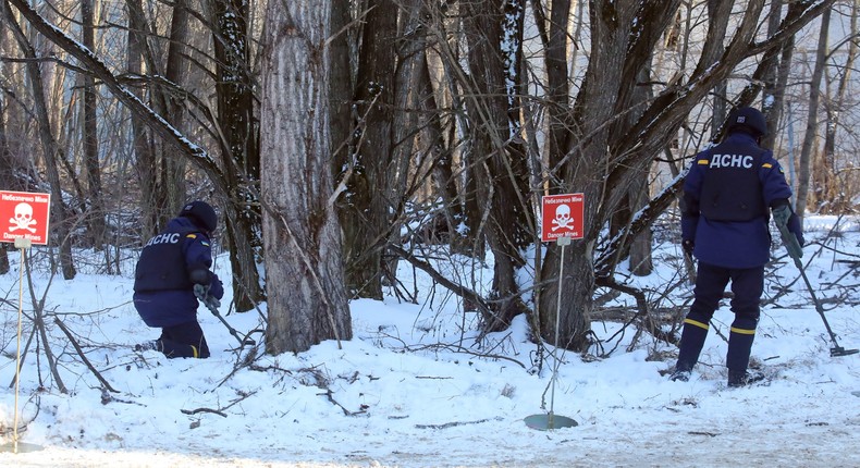 Rescuers search for land mines during tactical drills in northern Ukraine on February 4, 2022.