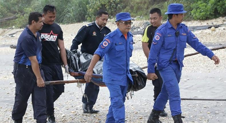 Rescuers carry a body retrieved from near the area where a boat carrying Indonesian immigrants capsized in Mersing, in Malaysia's southern Johor state in January