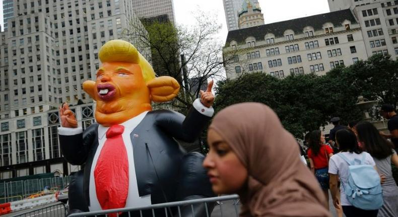 Protesters gather outside Trump Tower in New York to demonstrate against US President Donald Trump on August 14, 2017