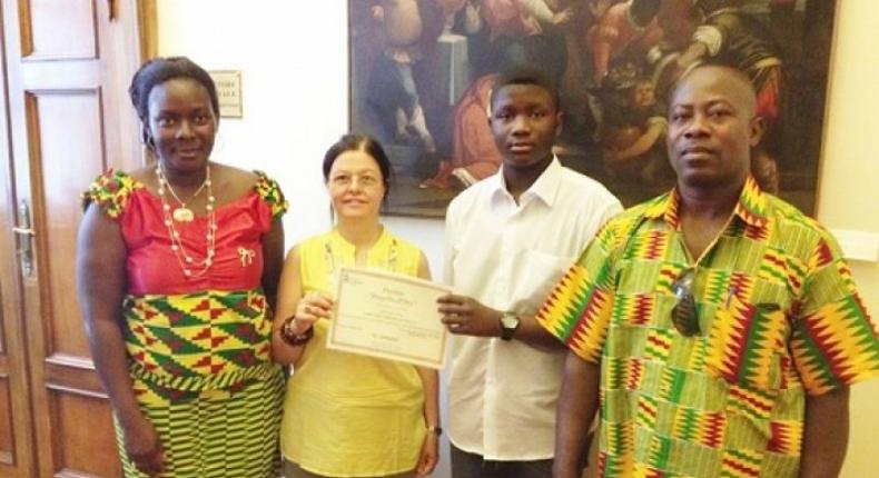 An official of the Santa Lucia education directorate (second left) presenting a certificate of merit to Master Emmanuel Sarpong Agyemang. Flanking them are the parents of Master Agyemang