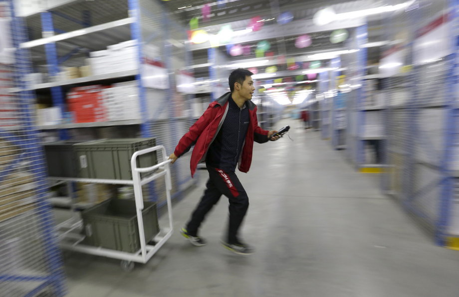 An employee works at a JD.com logistic center in Langfang, Hebei province in November 2015.