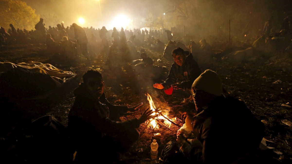 Migrants wait to cross the Slovenia-Austria border in Sentilj