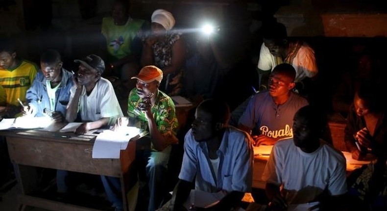 Electoral observers listen to and write vote counts at the end of the presidential and legislative elections, in the mostly muslim PK5 neighbourhood of Bangui, Central African Republic, February 14, 2016. REUTERS/Siegfried Modola