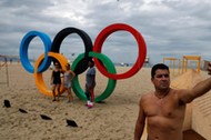 Man takes a selfie in front of the Olympic Rings, displayed at the Copacabana beach ahead of the 201