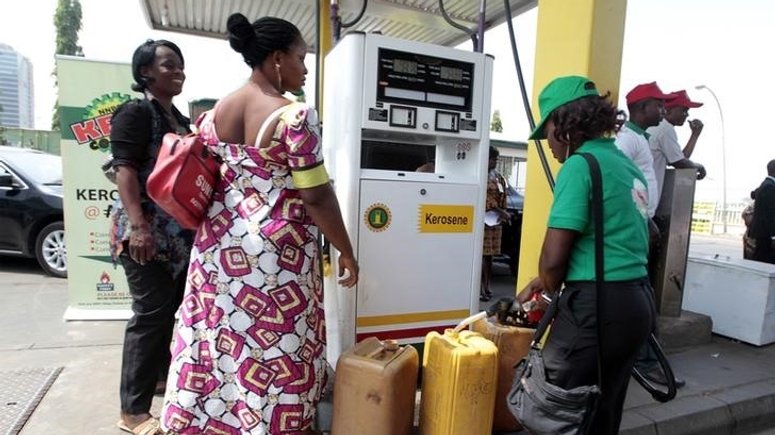 A fuel station attendant dispenses petrol at a Nigerian National Petroleum Corporation (NNPC) mega petrol station in Abuja. [REUTERS/ Afolabi Sotunde]