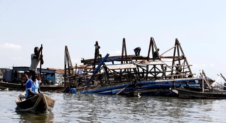 Residents work to dismantle the Makoko floating school after it collapsed in the Makoko fishing community on the Lagos lagoon, Nigeria June 8, 2016. 