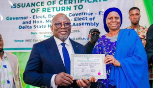 Delta Gôv. elect, Chief Sheriff Oborevwori receiving his certificate of return from INEC Nat. Commissioner, supervising Cross River, Delta and Edo States, Prof Rhoda Gumus on Wednesday in Asaba.