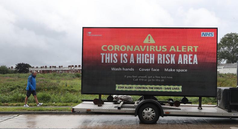 A mobile advertising vehicle displays a coronavirus high risk area warning in Oldham, Greater Manchester, on August 22, 2020.