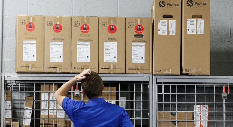 An employee checks computer inventory that's part of a Black Friday sale at a Best Buy on November 24, 2016, in Orem, Utah.