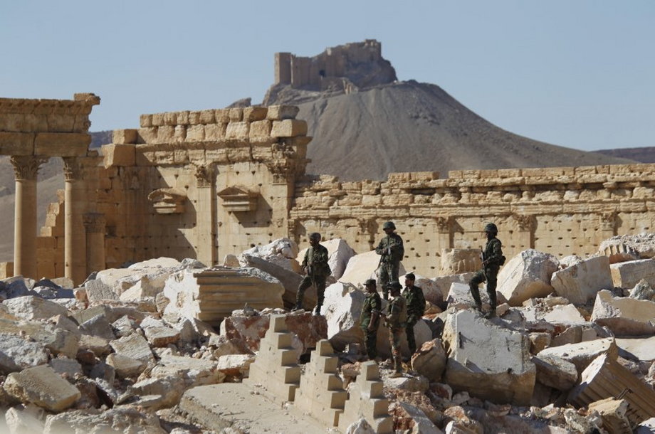 Syrian army soldiers stand on the ruins of the Temple of Bel in the historic city of Palmyra, in Homs governorate, Syria, April 1, 2016.