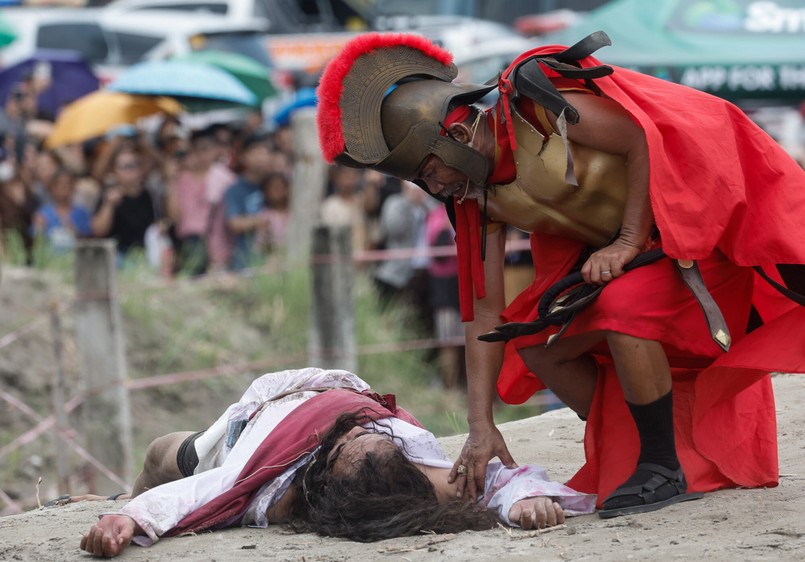 Catholic penitent nailed to cross on Good Friday in Holy Week of Lent