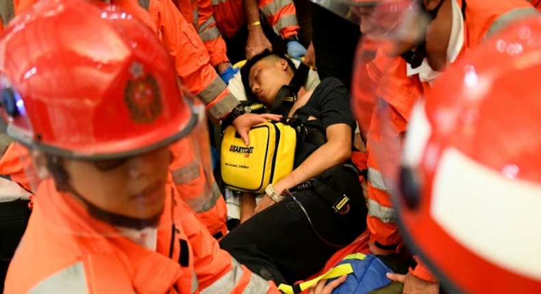 Two men were beaten by protesters at Hong Kong airport on Tuesday, one accused of being a Chinese spy and the other of being an undercover police officer