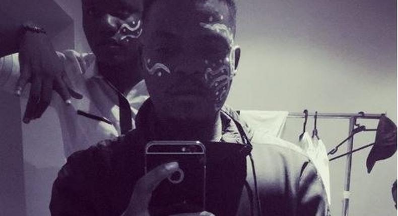 Olamide reconnects with Fela with his white paint on his face 