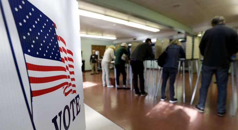 FILE - In this Nov. 6, 2018, file photo, voters cast their ballots, in Gates Mills, Ohio. An Associated Press review has found that thousands of Ohio voters were held up or stymied in their efforts to get absentee ballots by mail in 2018's general election because of a missing or mismatched signature on their ballot application. (AP Photo/Tony Dejak, File)