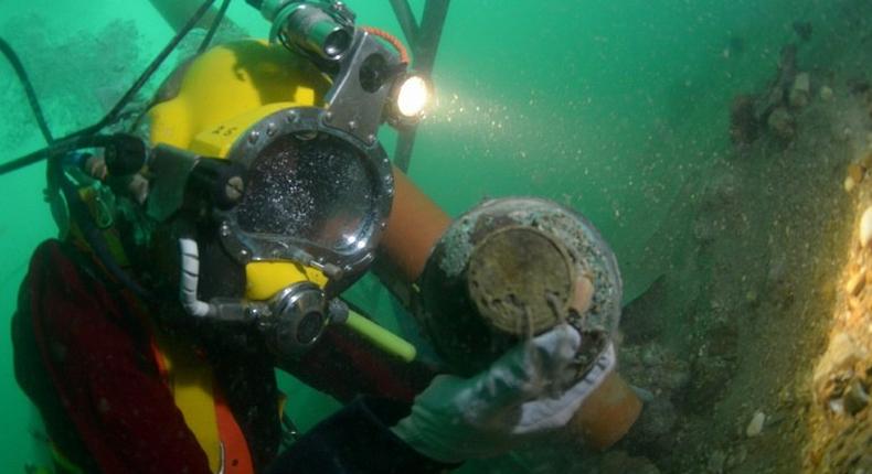 A diver works on the wreck of the Rooswijk, a Dutch East India Company ship which sank in 1740, on the sea bed off the coast of Ramsgate, southeast England, in a picture released by Historic England in London on August 18, 2017