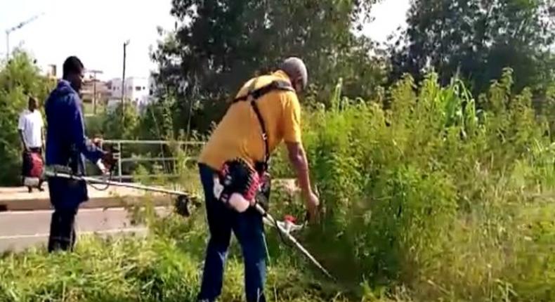 Mahama clears weeds in front of new Military Cemetary