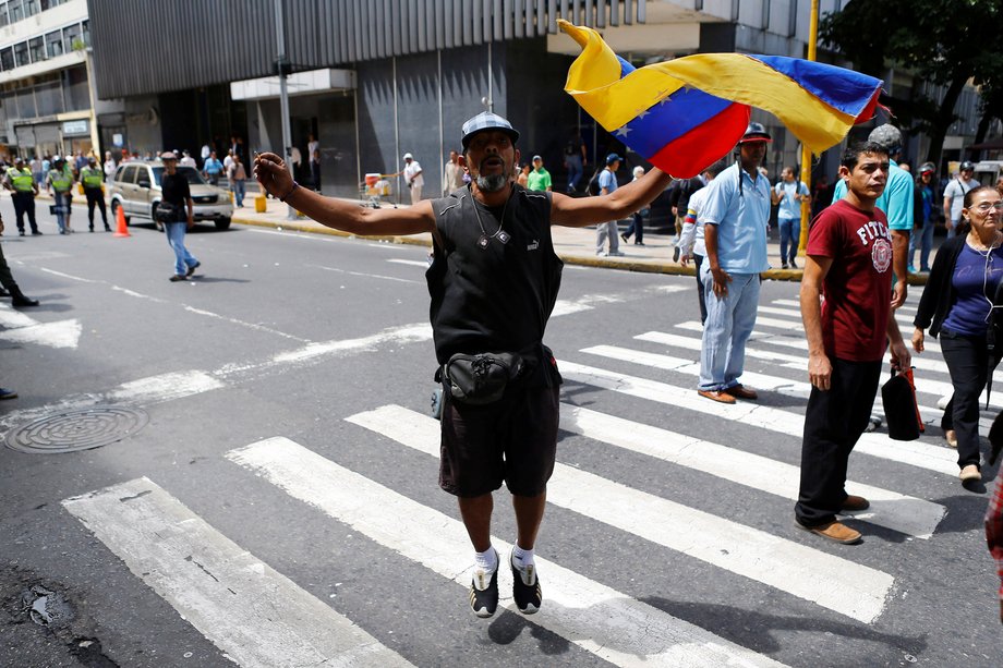 A supporter of Venezuela's President Nicolas Maduro shouts slogans against opposition lawmakers during a protest at the area of the elections council headquarters in Caracas, June 9, 2016.