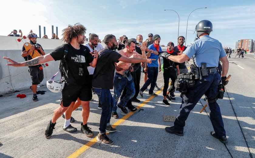 Protesters scale a truck that was driven into a rally