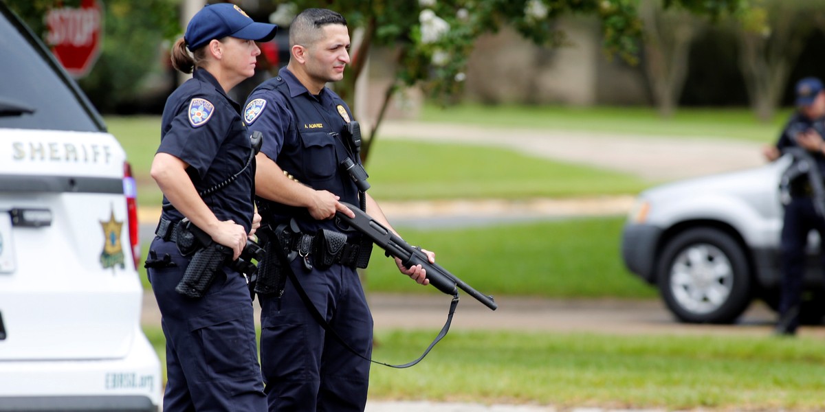 Law enforcement officers block Airline Highway near the site of a shooting of police in Baton Rouge, Louisiana.