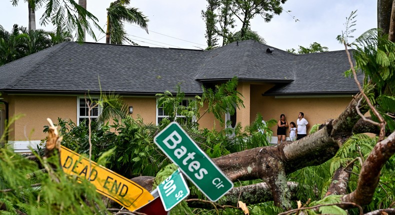 Oscar Garcia with his family outside his house after getting hit by a reported tornado in Fort Myers, Florida.CHANDAN KHANNA/AFP/Getty Images