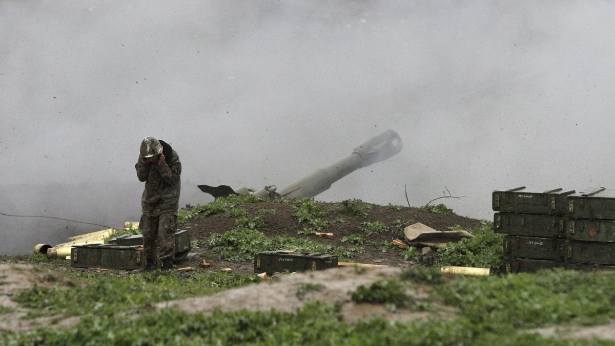 An Armenian serviceman of the self-defense army of Nagorno-Karabakh launch artillery toward Azeri forces in the town of Martakert in Nagorno-Karabakh region