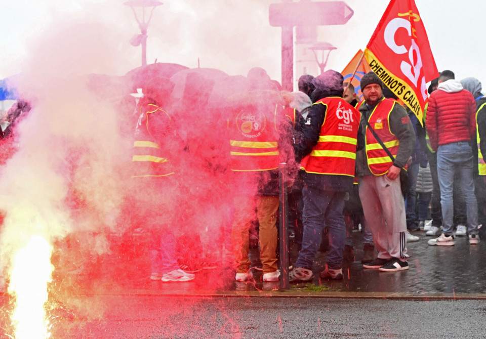 Związkowcy z Confederation Generale du Travail (CGT) protestują, paląc race na Place d'Armes w Calais, w północno-zachodniej Francji, 7 marca 2023 r.