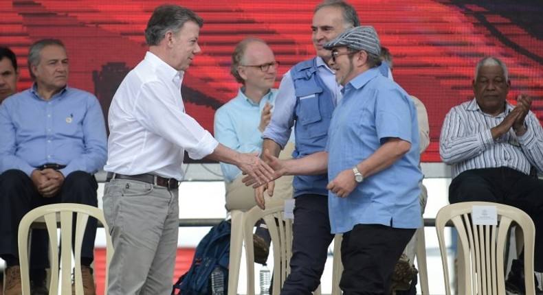 FARC rebel leader Rodrigo Londono Echeverri (R), Colombian president Juan Manuel Santos (L) and the UN Special Representative for Colombia Jean Arnault (C) attend the final act of abandonment of arms in June 2017