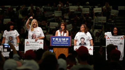 Women representing Stolen Lives families take part in a Trump rally in Anaheim