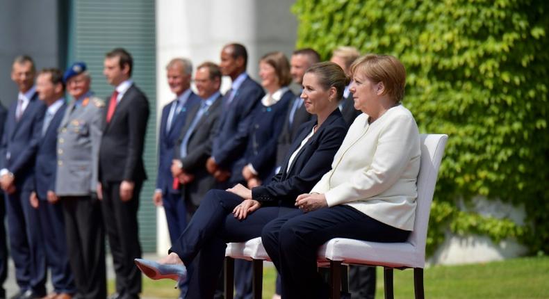 German Chancellor Angela Merkel and Denmark's Prime Minister Mette Frederiksen sat as they listened to the national anthems